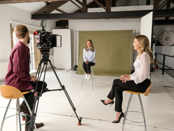 A stock image of three people in a room for a mock press interview